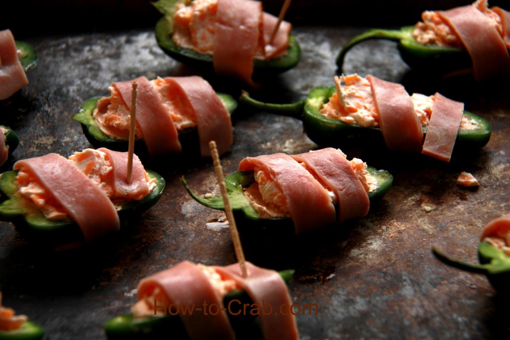 Bacon wrapped, cream cheese and crab filled jalapeno peppers.